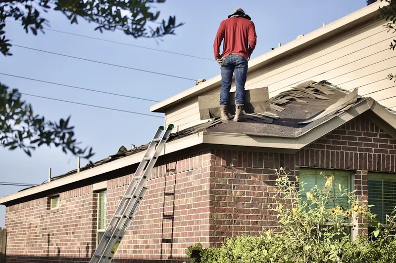 Professional roofer working on a residential roof in Peachtree Center